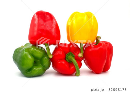 Red, green and yellow bell peppers on white Red, green and yellow bell peppers on white 82098173