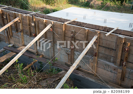 Construction site. The timber formwork is prepared for pouring concrete. The metal fittings are also visible. The process of building a private house Construction site. The timber formwork is prepared for pouring concrete. The metal fittings are also visible. The process of building a private house 82098199