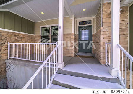 Snow covered front steps and porch day light Snow covered front steps and porch day light 82098277