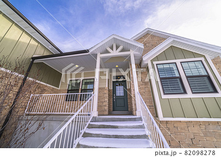 Snow covered steps leading to a front door 82098278