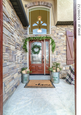 Front door to a house decorated with green wreath Front door to a house decorated with green wreath 82098732