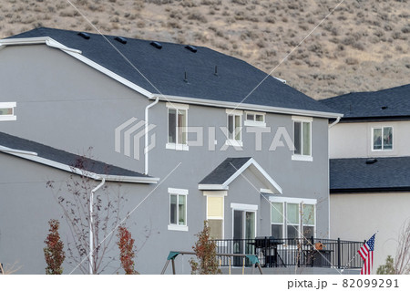 American flag in front of a modern home 82099291