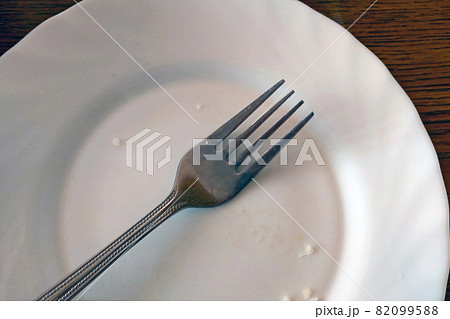 Empty plate with fork after eating, dirty Empty plate with fork after eating, dirty 82099588