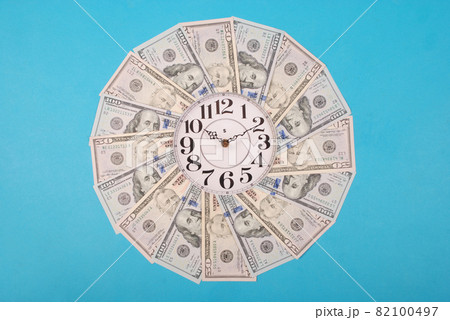 Concept of clock and dollar. Clock on kaleidoscope from money. Concept of clock and dollar. Clock on kaleidoscope from money. 82100497