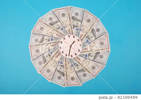 Concept of clock and dollar. Clock on kaleidoscope from money. Concept of clock and dollar. Clock on kaleidoscope from money. 82100499