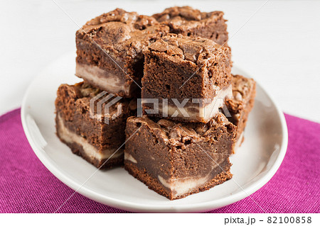 marble chocolate brownies with mascarpone are stacked on a plate 82100858