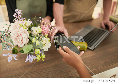 Woman Paying in Flower Shop Woman Paying in Flower Shop 82101574
