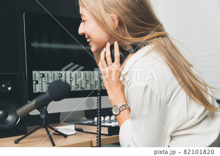 sound engineer woman headphone editor control audio mixing panel studio recording. sound engineer woman headphone editor control audio mixing panel studio recording. 82101820