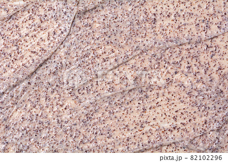 Clay face scrub texture. Microparticles in cosmetics. Sample of cosmetic products. Clay face scrub texture. Microparticles in cosmetics. Sample of cosmetic products. 82102296