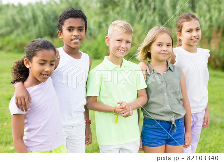 Portrait of happy children on green grass on sunny day 82103340