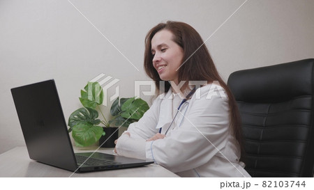Communication with a doctor through a web camera of an electronic laptop application, treatment and consultation of a doctor online, computer technology in the work of medicine, the concept of life 82103744