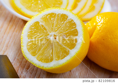 Lemon and knife on cutting board 82109816