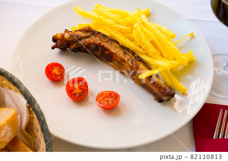 Barbecued ribs with french fries Barbecued ribs with french fries 82110813