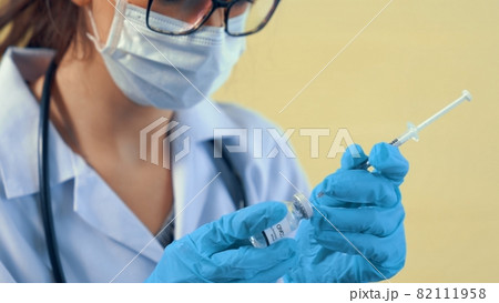 Skillful doctor prepare vaccine proficiently before injection 82111958