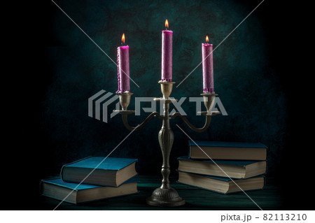 Study of magic. Old books and purple candles 82113210