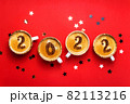New year 2022 is drawn on cups of coffee on red background 82113216