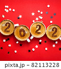 New year 2022 is drawn on cups of coffee on red background 82113228