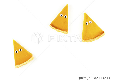 Three slices of pumpkin pie in form of Halloween ghost with eyes on white isolated background with copy space. Festive creative food concept Three slices of pumpkin pie in form of Halloween ghost with eyes on white isolated background with copy space. Festive creative food concept 82113243
