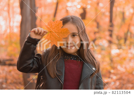 Asian child girl laughing and playing in the autumn on the nature walk outdoors 82113504