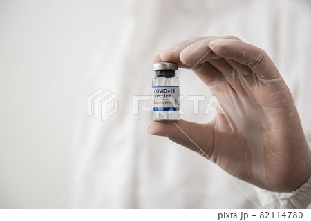 Doctor Hands in protective gloves holding covid-19 test dose. Doctor Hands in protective gloves holding covid-19 test dose. 82114780