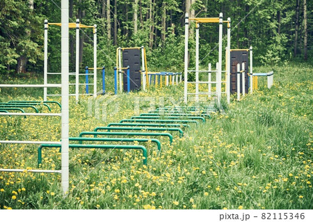Sports ground with trainers on green lawn with flowers Sports ground with trainers on green lawn with flowers 82115346