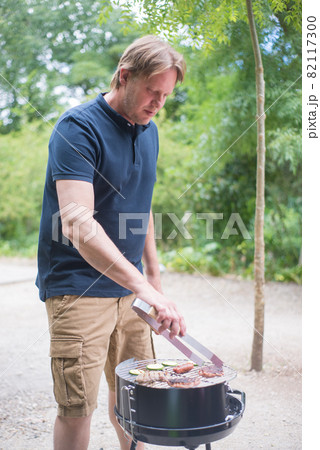Concentrated father making BBQ 82117300