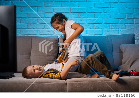 cheerful boy and girl having fun at home together cheerful boy and girl having fun at home together 82118160