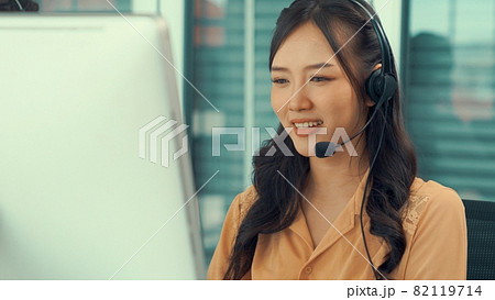 Businesswoman wearing headset working actively in office Businesswoman wearing headset working actively in office 82119714