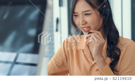 Businesswoman wearing headset working actively in office 82119810