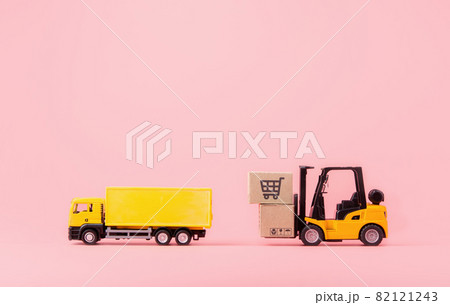 Logistics, and delivery service - Cargo truck, Forklift and paper cartons or parcel with a shopping cart logo on Pink background. Shopping service on The online web and offers home delivery. with copy Logistics, and delivery service - Cargo truck, Forklift and paper cartons or parcel with a shopping cart logo on Pink background. Shopping service on The online web and offers home delivery. with copy 82121243
