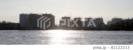 Silhouette, Back view of oil storage tanks in the export port, the oil business that exports by ships. Silhouette, Back view of oil storage tanks in the export port, the oil business that exports by ships. 82122213