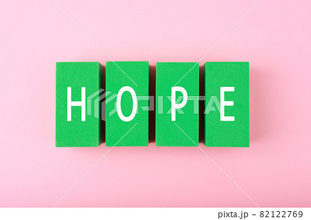 Hope single word written on green blocks against bright pink background Hope single word written on green blocks against bright pink background 82122769
