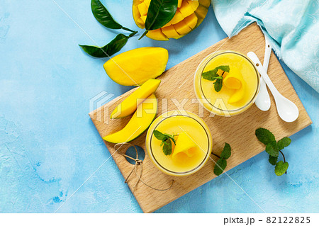 Homemade dessert panna cotta with mango jelly. Copy space, top view flat lay background. Traditional italian dessert. Homemade dessert panna cotta with mango jelly. Copy space, top view flat lay background. Traditional italian dessert. 82122825