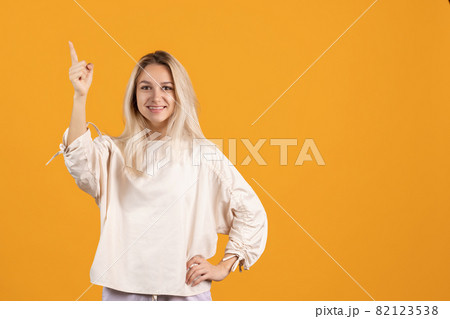 One beautiful caucasian girl posing isolated over yellow background 82123538