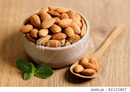 Almonds in a bowl on wooden table Almonds in a bowl on wooden table 82123807