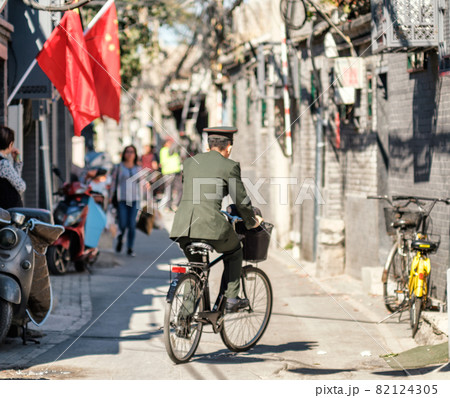 Chinese soldier riding a bicycle in Beijing, China 82124305