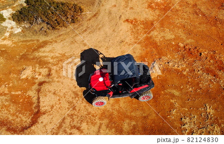 Aerial view of buggy car on the sandy on the sea coast of Cyprus or Greek in summer. Extreme trip off road place. Outdoor adventure for tourists 82124830