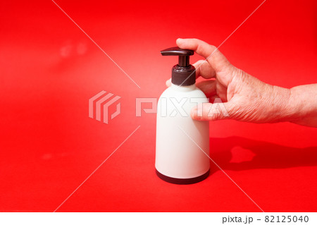 Woman push liquid soap squeezed out to hand. 82125040