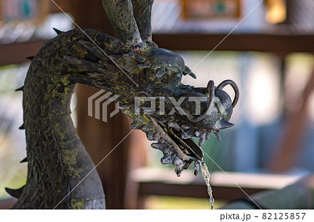 Dragon shaped water tap for washing hands at the Shinto shrine in Nara, Japan 82125857