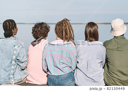Rear view of young intercultural friends in casualwear 82130449