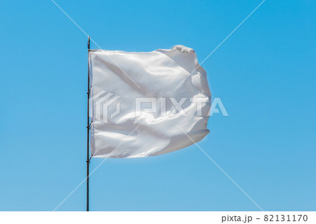 White flag sign and symbol of goodness and truce on blue sky background White flag sign and symbol of goodness and truce on blue sky background 82131170