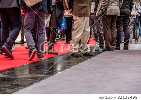 Low section of businessman and woman's legs walking on red carpet Low section of businessman and woman's legs walking on red carpet 82132498