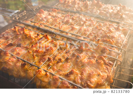 Cooking barbecue chicken meat food on the grill with smoke, outdoor rest 82133780