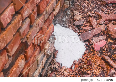 White ammonia saltpeter, fertilizer woke up through the destroyed old brick wall of the industrial warehouse with fertilizer 82133890