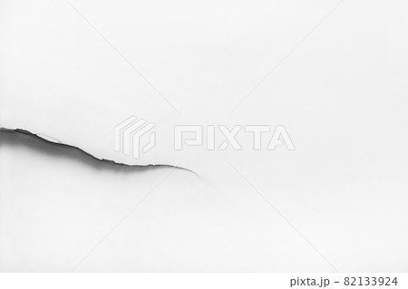 Large crack on a white damaged wall, broken light background, copy space, close-up 82133924