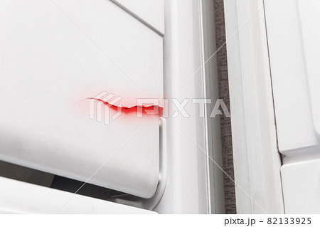 Crack on the polystyrene lid of the refrigerator freezer, close-up. The need to repair the refrigerator 82133925