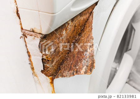 Rusty peeling corner layer from an old broken washing machine. Home appliances wear concept 82133981