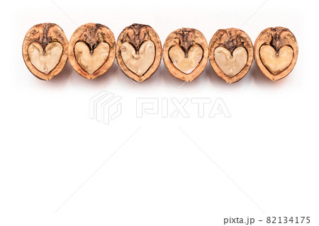 Walnut in a cut halves in the form of a heart isolated on a white background, copy space or mock up design 82134175