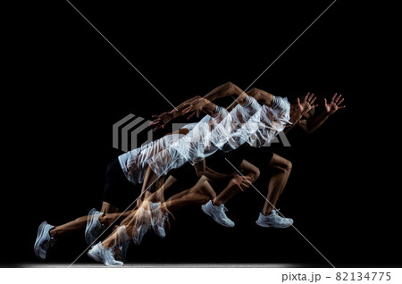 Full-length portrait of young male professional athlete running, training isolated over black studio background. Stroboscope effect Full-length portrait of young male professional athlete running, training isolated over black studio background. Stroboscope effect 82134775