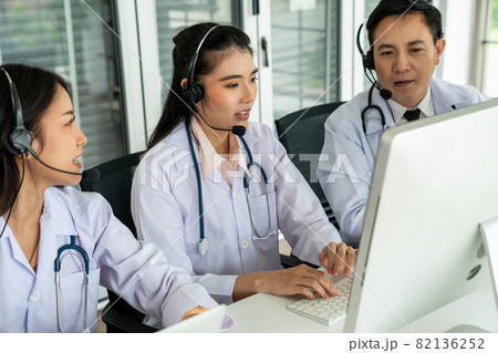Doctor team wearing headset talking actively on video call in hospital clinic 82136252